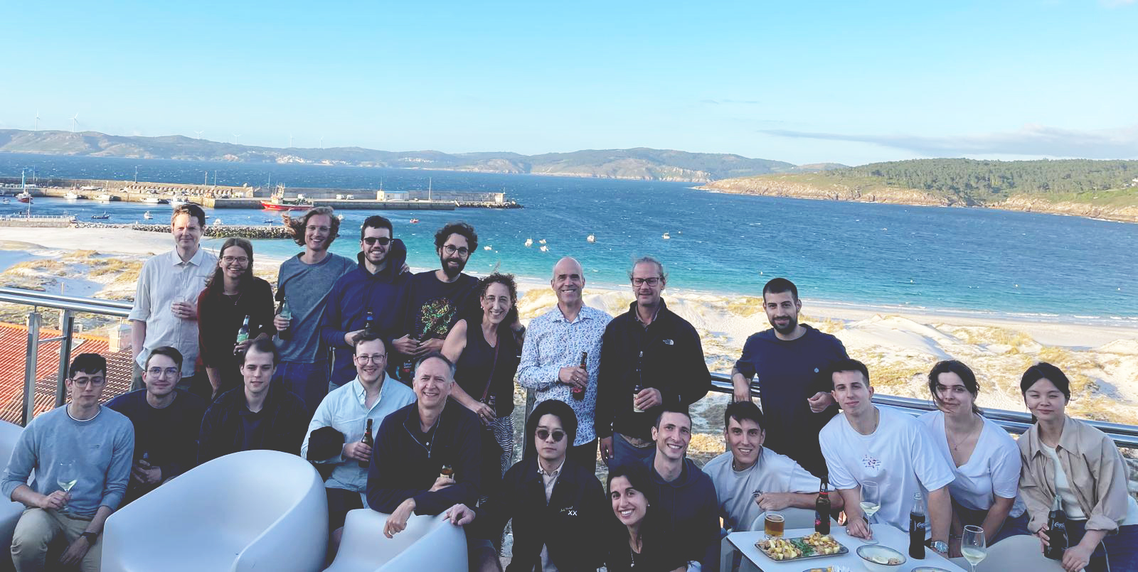 Group photo of MolDAM meeting participants by the sea